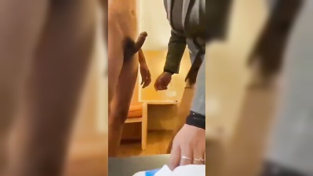 Mother is teaching son how to use a condom